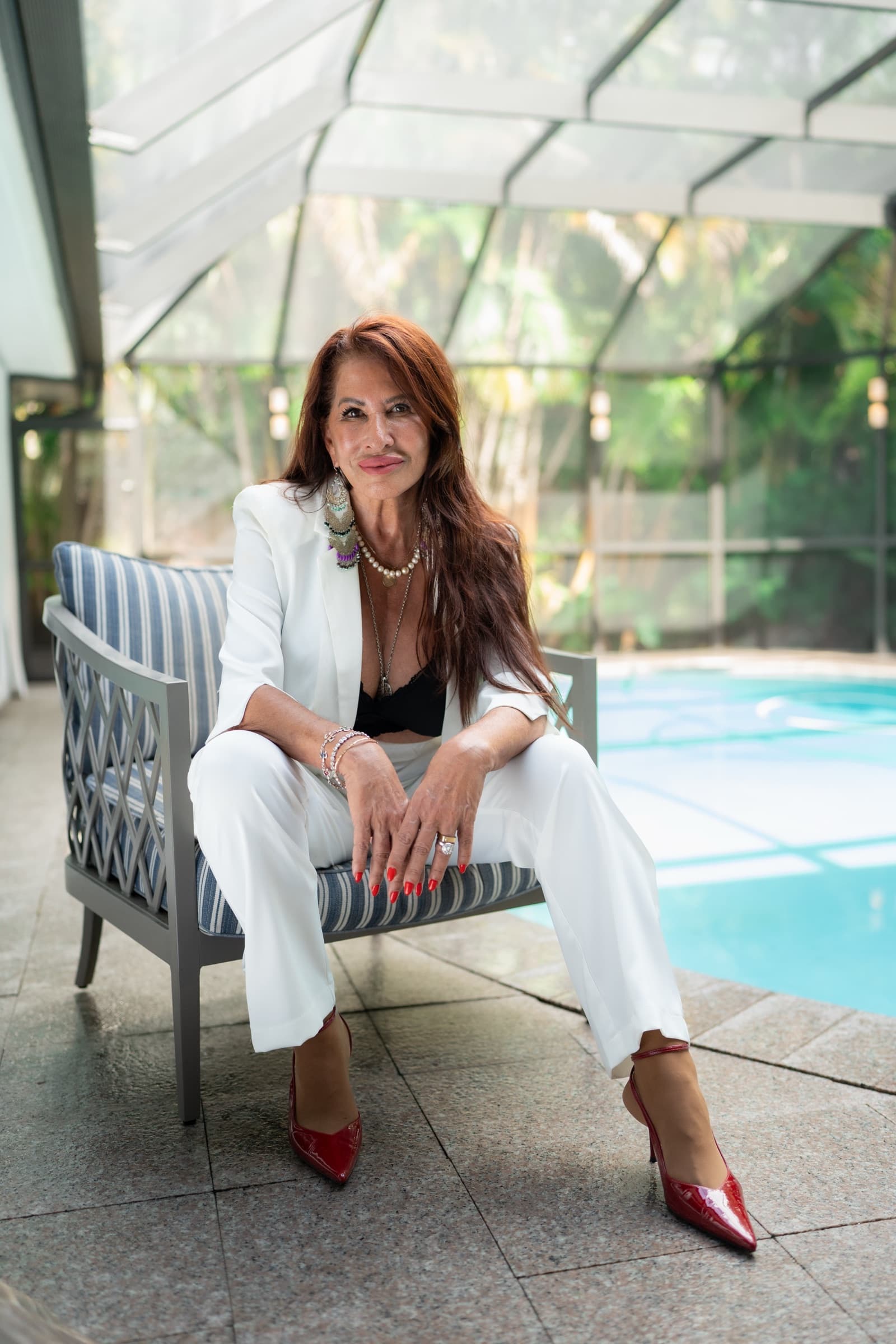 Ariel Yankelewitz seated in a glass conservatory